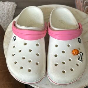 Crocs for women size 11 white with pink and basketball and #1 decoration.